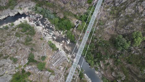 Guy walking on Arouca 516 suspension bridge in Portugal