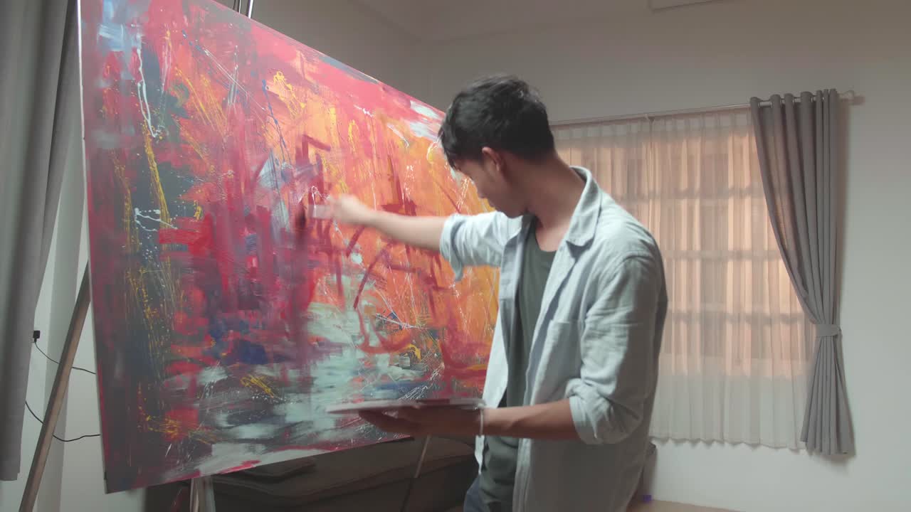 Asian Male Uses Paint Brush To Create Daringly Emotional Modern Picture