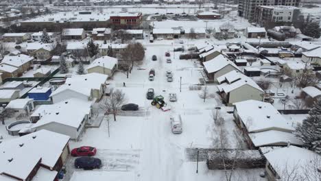 quiet suburban neighborhood blanketed in fresh winter snow with a snowplow vehicle, st-constant, québec, canada.
