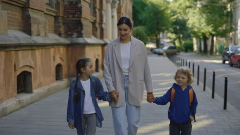 mother and children walking to school