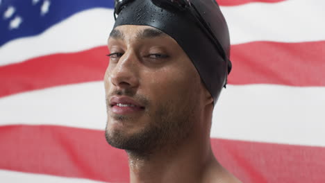 Young-biracial-athlete-swimmer-in-swim-gear-poses-confidently