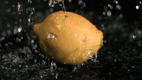 water falling on lemon in super slow motion