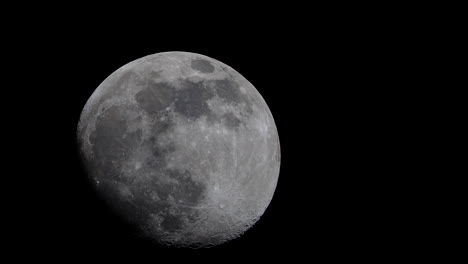 the moon in its waxing gibbous phase, crosses the night sky in spectacular detail - time lapse