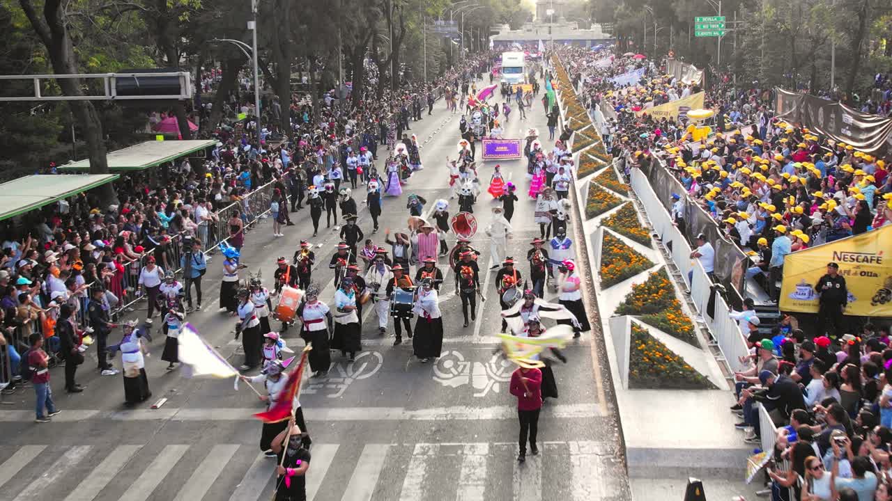 Vibrant street parade with people in traditional costumes and large crowds
