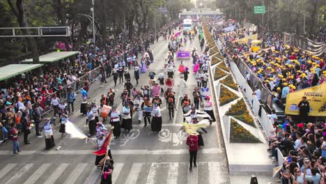 vibrant street parade with people in traditional costumes and large crowds
