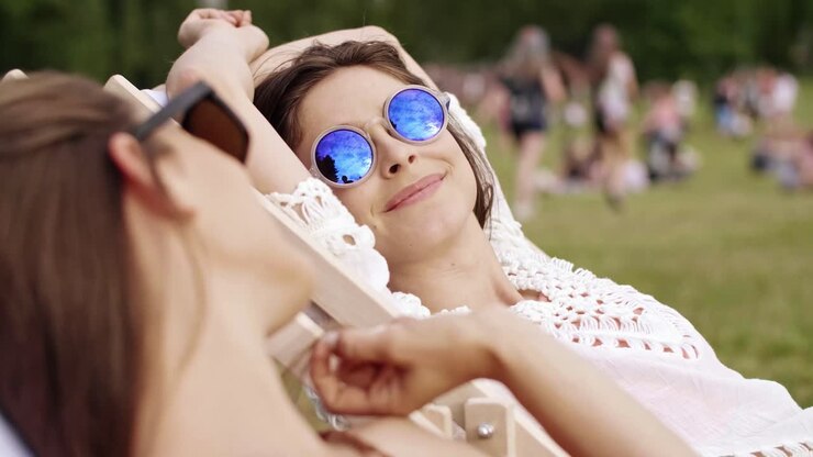 Two young women sunbathing in the summer