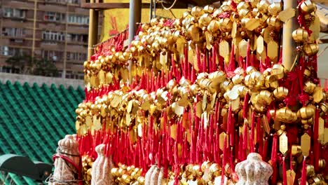 rows of golden bells with red ribbons