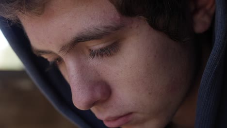 closeup of a teenage boy looking sad and depressed