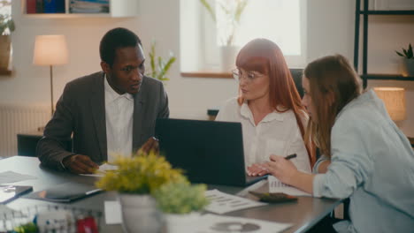 Multiracial-coworkers-discussing-strategy-in-meeting.