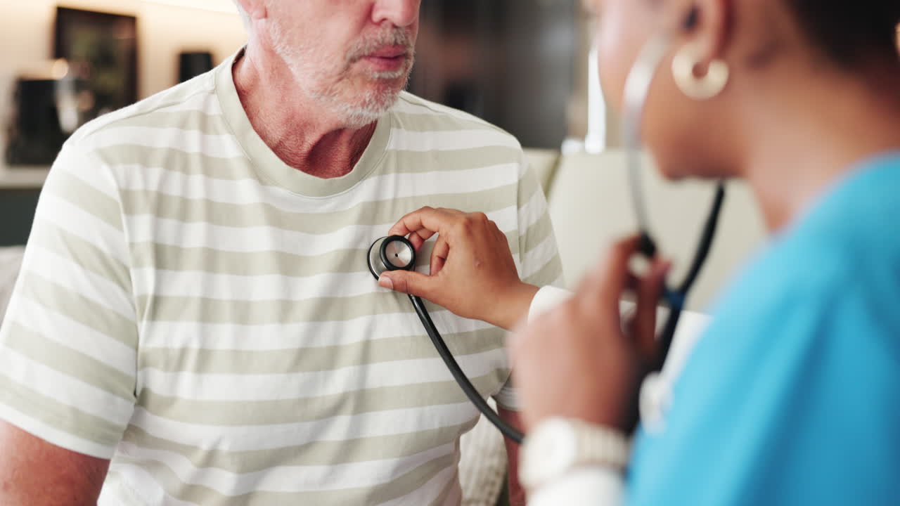 Doctor Using Stethoscope to Examine Senior Male Patient's Chest