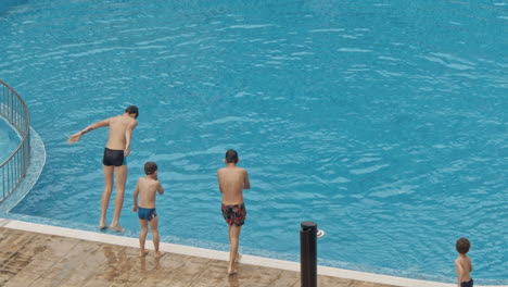 happy family with kids having fun in swimming pool