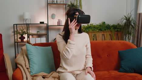 woman using virtual reality futuristic technology headset to play simulation 3d video game at home