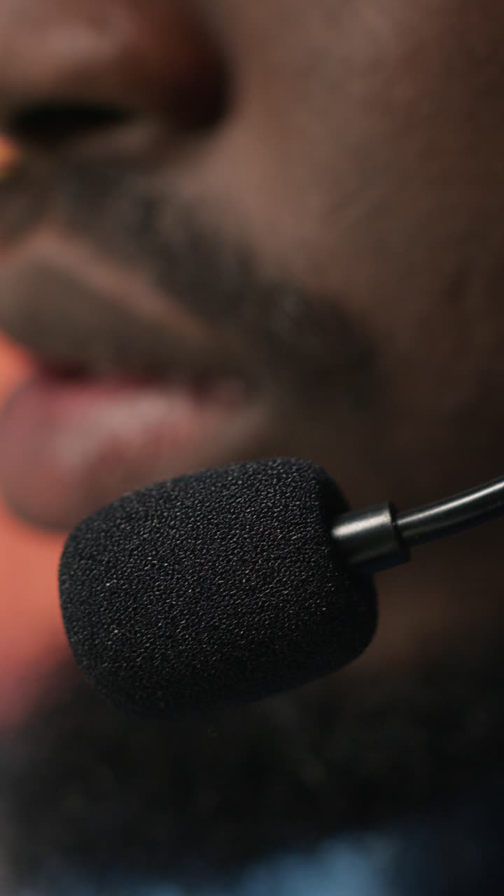 Vertical video Extreme closeup of call center agent using audio headset microphone