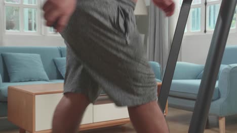 overweight man exercising on treadmill at home
