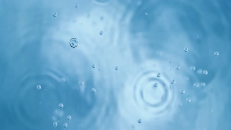 oxygen bubbles in water on a blue abstract background on super slow motion.