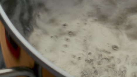extreme close-up of hot water boiling in pot during food preparation
