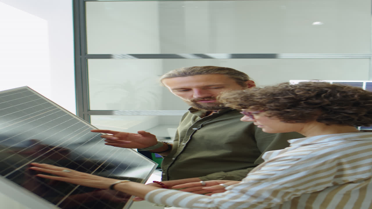 Renewable Energy Engineers Talking about Solar Panel