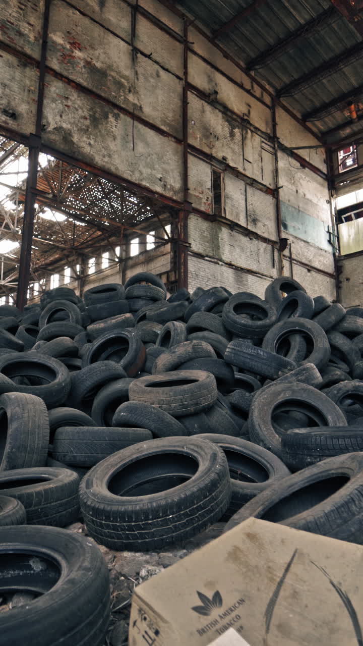 Old tires at a dump. Pile of old tires stacked in junkyard panned up from base to top Vertical video