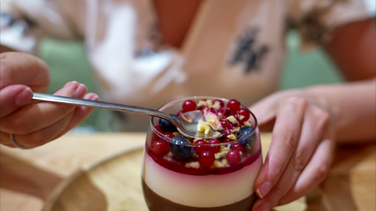 Woman eating a fruit jelly at an italian restaurant