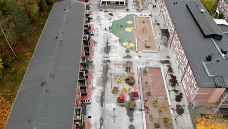 Aerial-top-down-view-kids-Playground-between-Residential-buildings,-Sweden