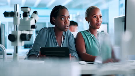 two women scientists collaborating in a laboratory setting