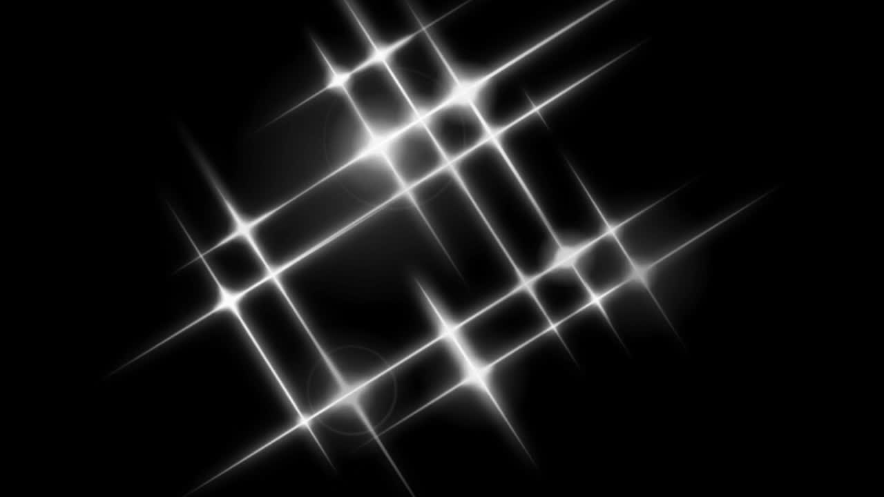 Animation white light sparkles on black background.