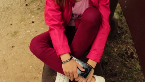 girl with red jacket sitting in the park