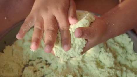 child playing with green kinetic sand