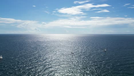 drone shot moving away from the horizon revealing boats