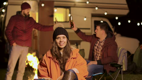 Girl-sitting-on-a-camping-chair-in-a-cold-night-of-autumn