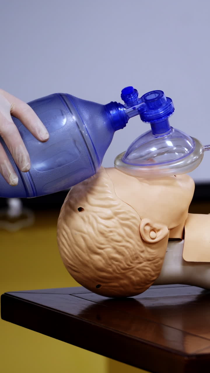 Medical simulation mannequin used for practicing techniques with oxygen mask. Healthcare and education. Vertical video