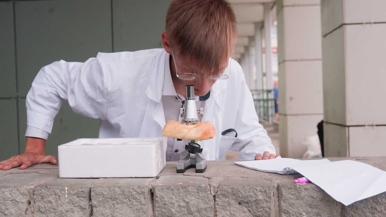 Biologist in white coat rises up after carefully examining pastry closely through microscope outdoors, reflecting curiosity, focus, scientific research, and unique study of unusual subject matter