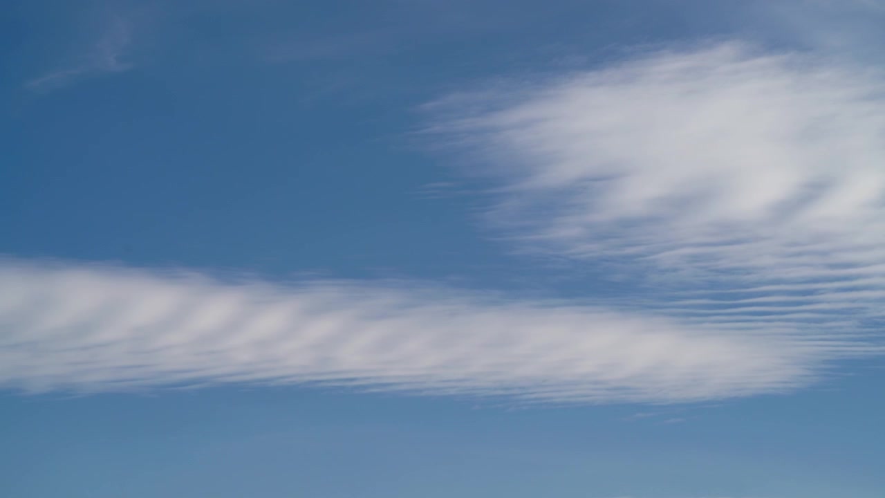 Time-lapse af tynde skyer, der bevæger sig hen over en klar blå himmel