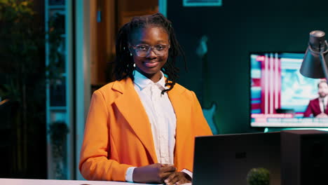 Portrait-of-university-student-sitting-at-desk-using-laptop-to-do-school-tasks