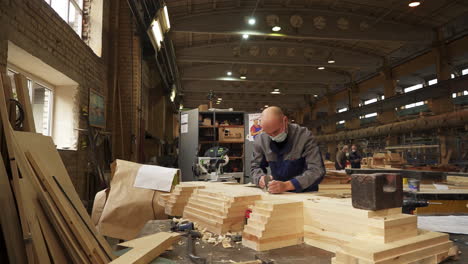 woodworker using a plane in a factory setting