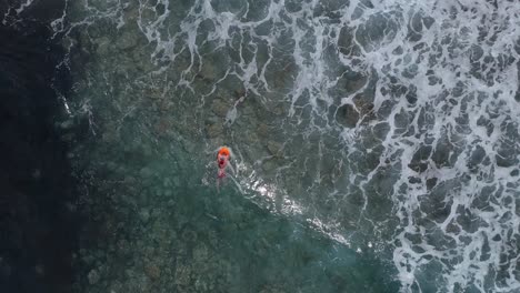 a swimmer in the sea rides the waves with a motorized water scooter