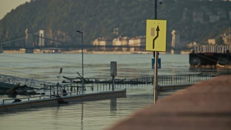 budapest flood: danube river overflowing, chain bridge in background