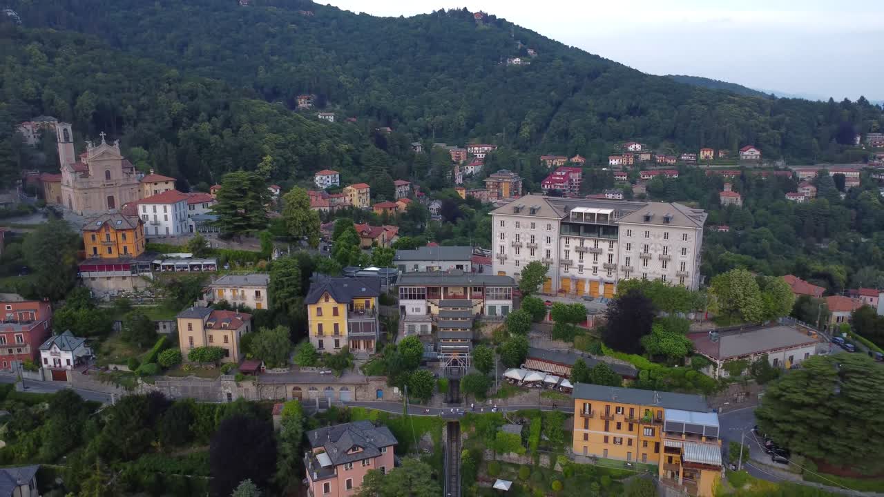 Drone perspective over Brunate neighbourhood perched above Lake Como, with Como-Brunate funicular - Italy