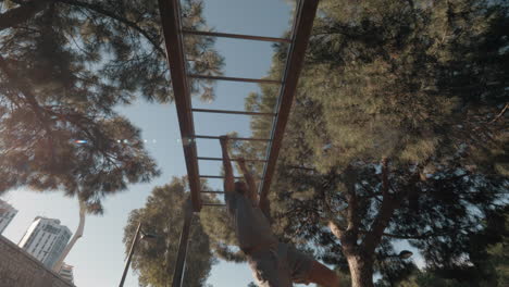 workout on monkey bar in the park