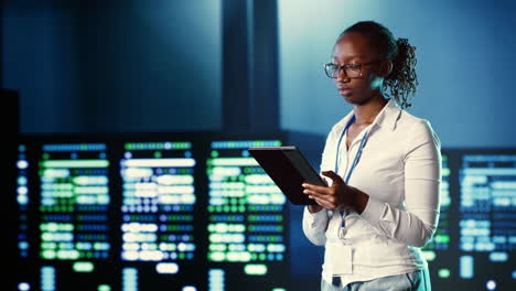 woman walks through data center systems