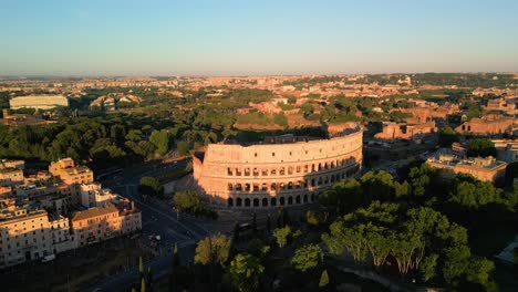 forward drone shot towards ancient roman colosseum at sunrise
