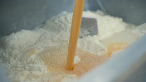 mixing dough ingredients in a bowl