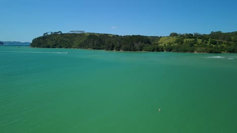 aerial view of fishing boat in the ocean passing sand banks at high tide