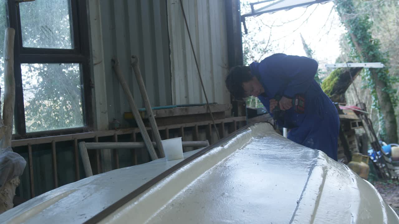 Drilling keel band on bottom of fiberglass fishing boat