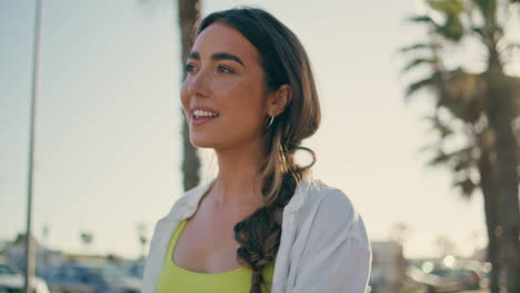 carefree woman strolling summer boardwalk close up. smiling girl crossing alley