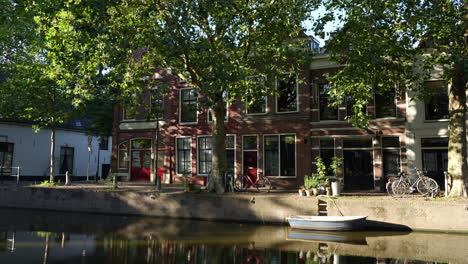 Casas-Del-Canal-En-La-Calle-Lage-Gouwe-Durante-La-Tarde-Soleada-En-El-Casco-Antiguo-De-Gouda,-Holanda-Del-Sur,-Países-Bajos