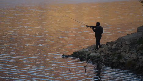 fisherman at sunset by the lake