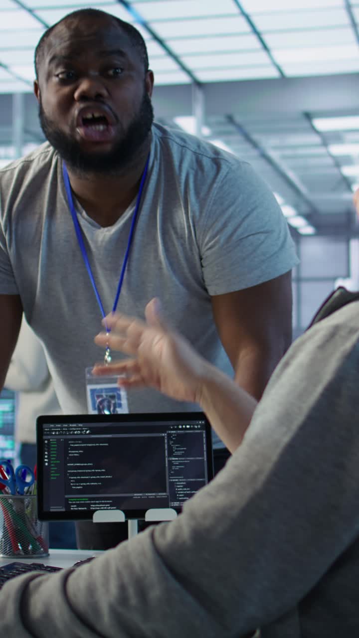 Vertical video Engineer having fun with colleague at work in data center, doing fist bump