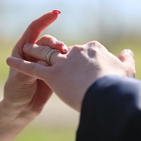 the groom puts the wedding ring on finger of the bride. just married. the bride and groom exchange wedding rings.