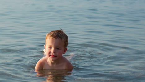 smiling little boy in the sea